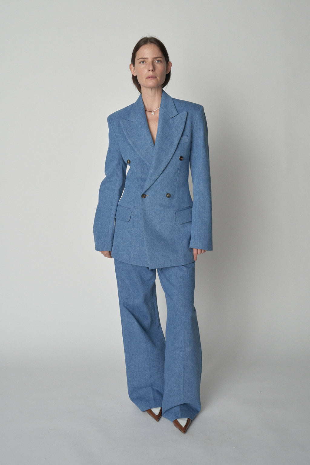 Full front view of model wearing Bettter denim blazer and trouser.