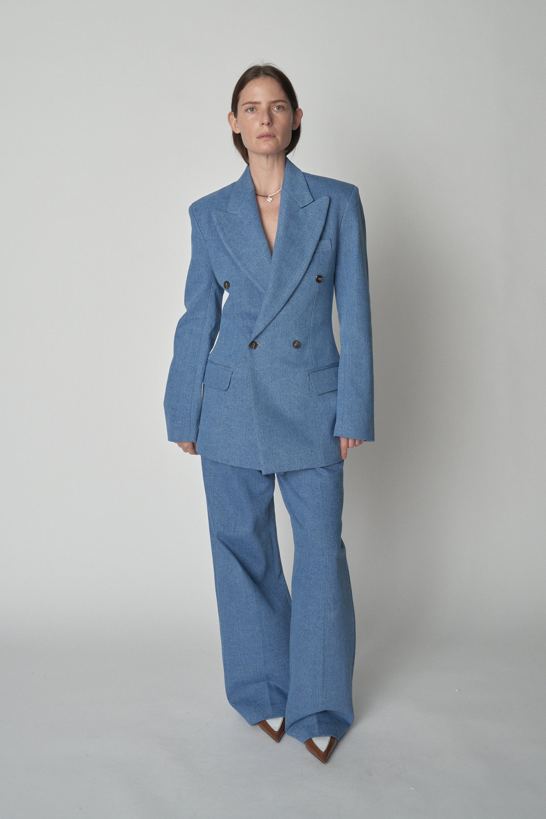 Full front view of model wearing Bettter denim blazer and trouser.