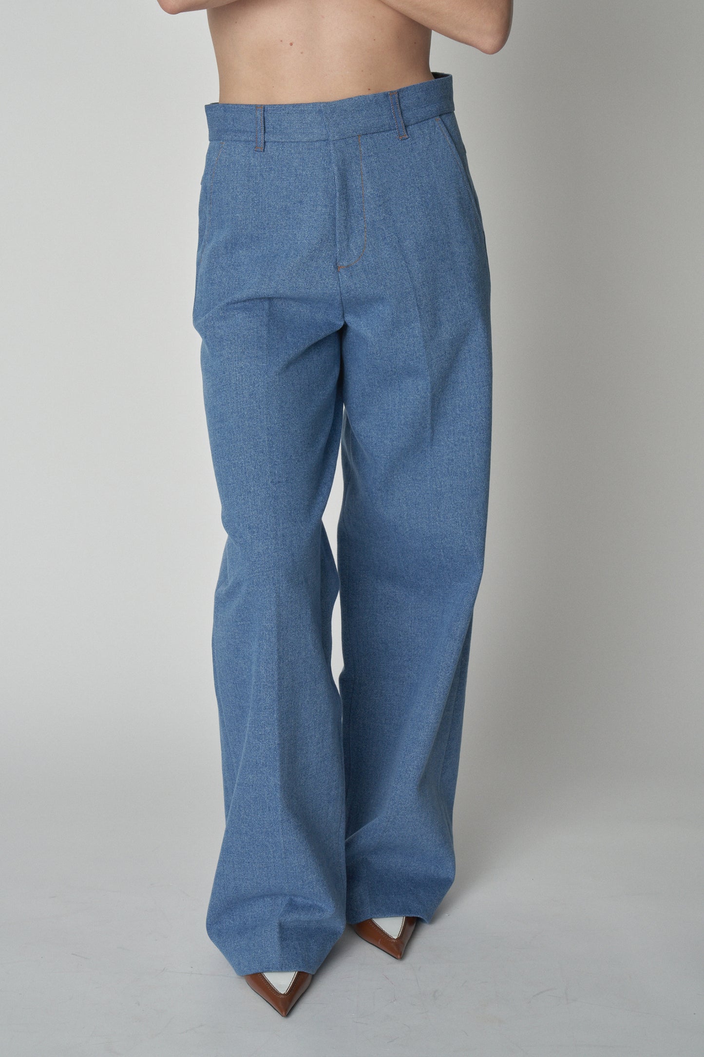 Front waist down view of model wearing Bettter denim trousers.