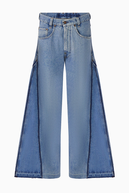 Front view of wide leg jeans with additional denim panel.