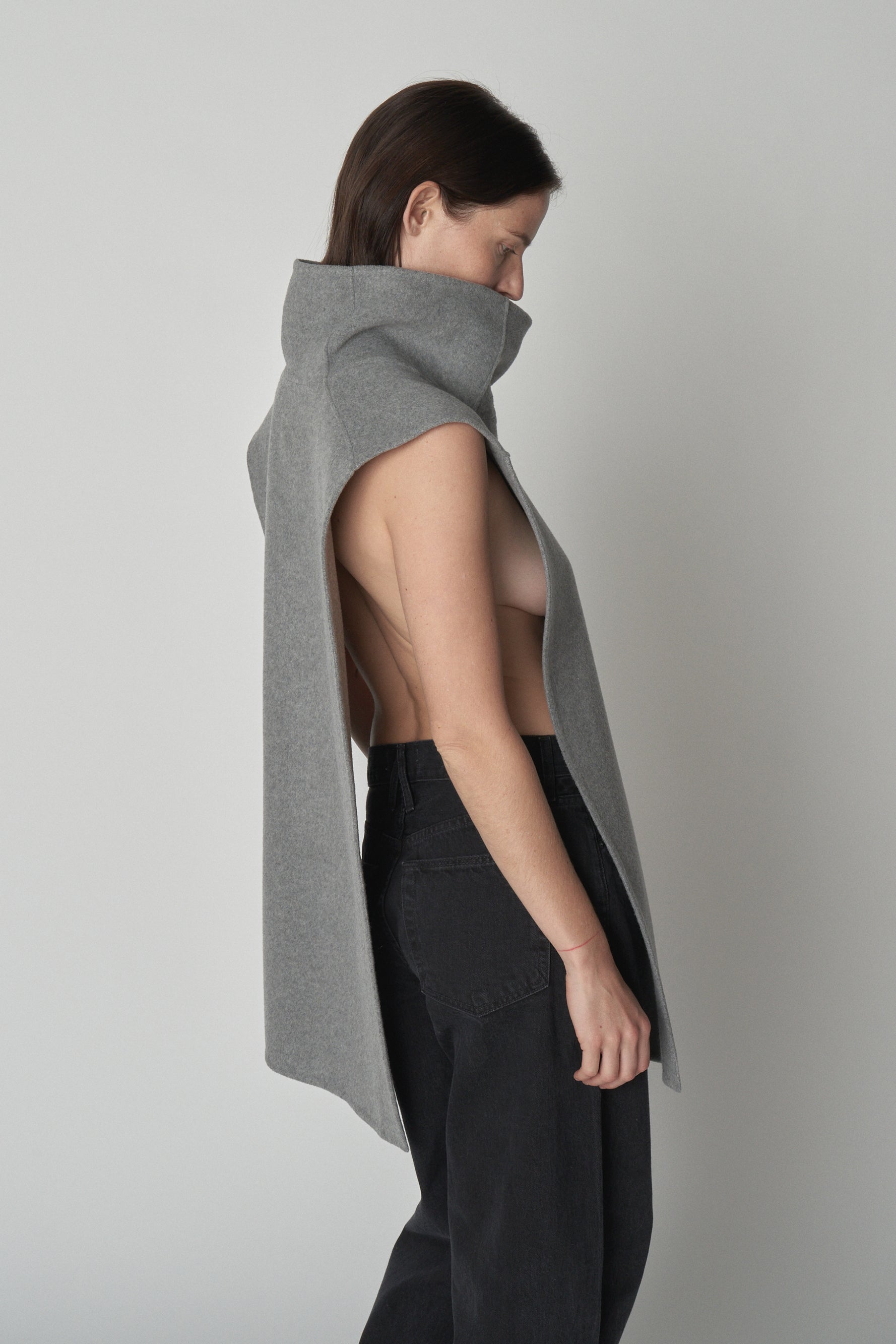 Side view of model wearing grey wool gillet.