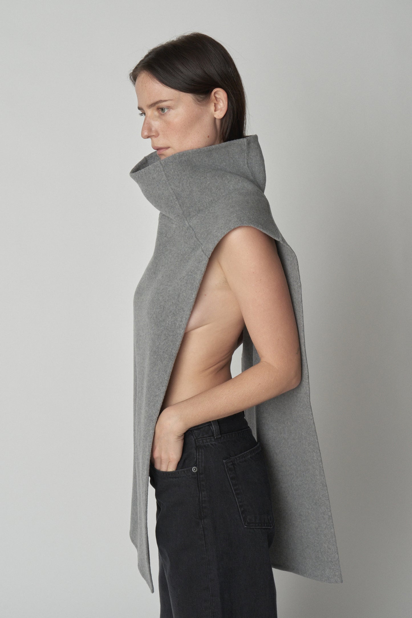 Side view of model wearing grey wool gillet.