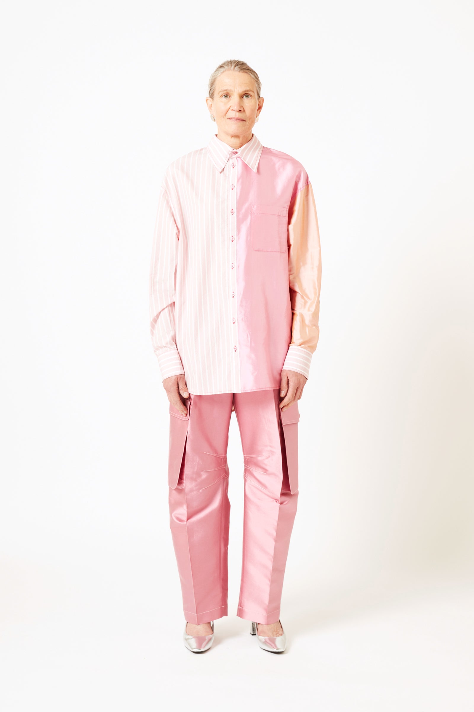 Front view of model wearing mauve silk cargo pants and pink striped cotton shirt.