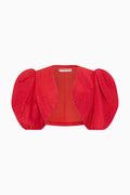 A red Saint Laurent bolero with puff sleeves and a square neckline.