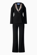 A Thierry Mugler black pantsuit with a sequinned collar.