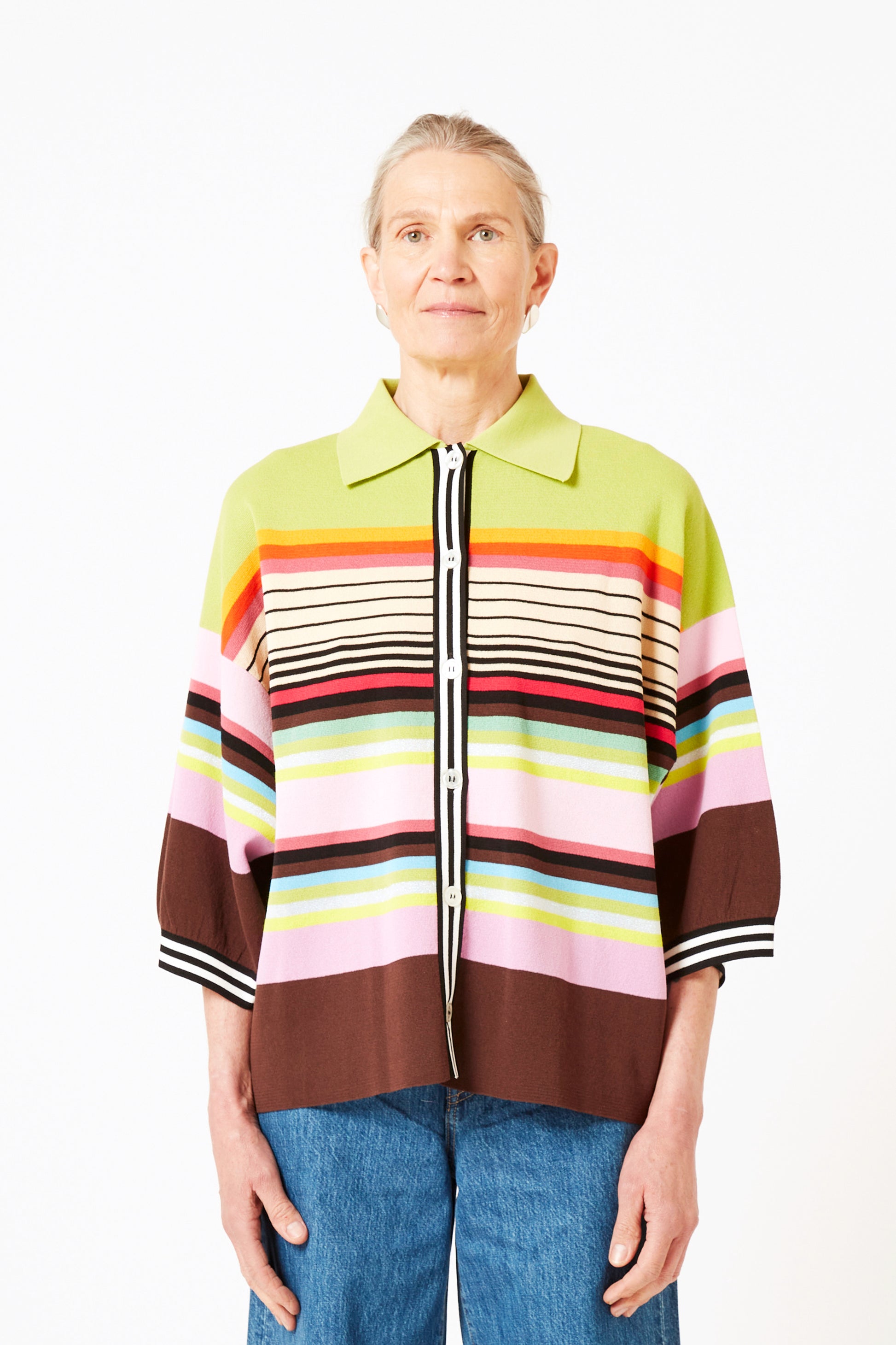 Front view of model wearing knit polo with graphic stripes and 3/4 sleeves.