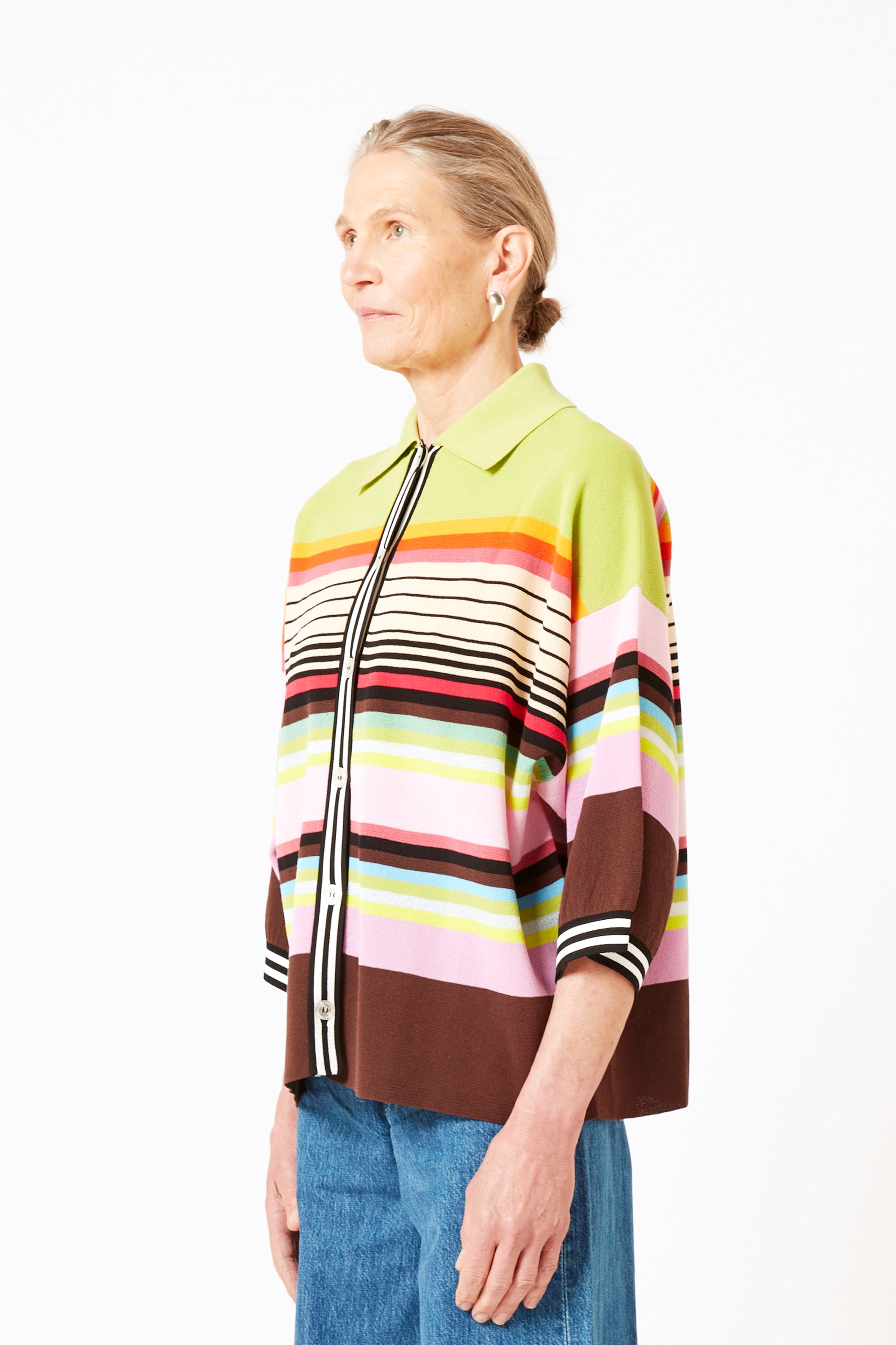 Front view of model wearing knit polo with graphic stripes and 3/4 sleeves.