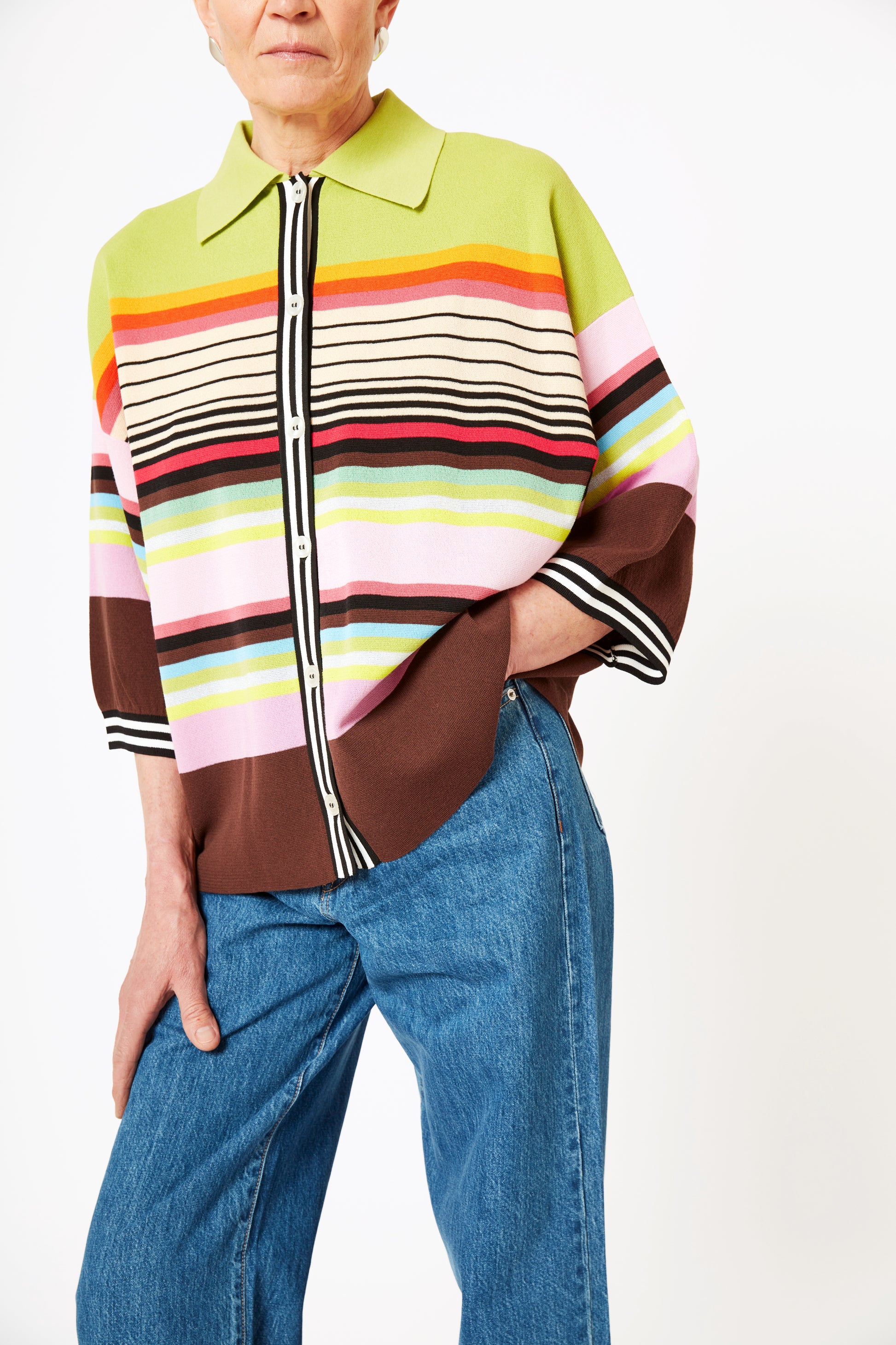 Front view of model wearing knit polo with graphic stripes and 3/4 sleeves.