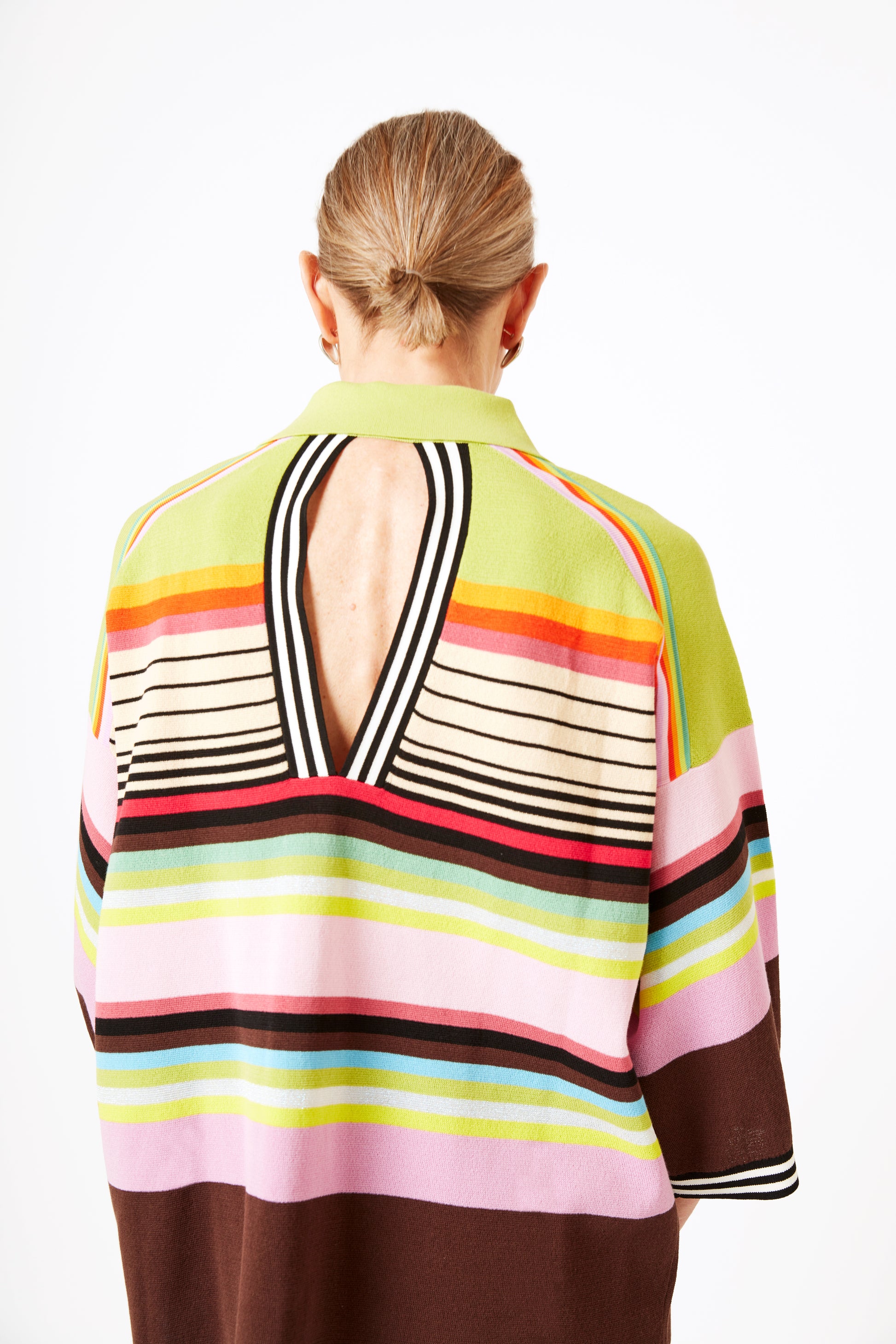 Reverse view of model wearing knit polo with graphic stripes and 3/4 sleeves.